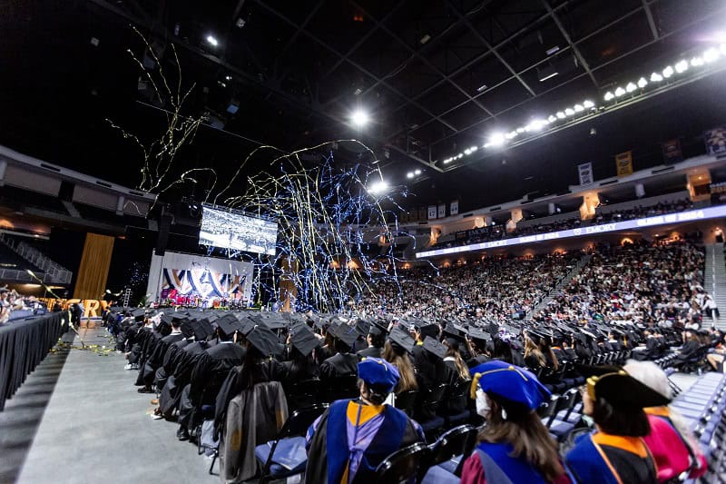 Streamers fall from the ceiling in celebration at Goizueta Commencement 2024