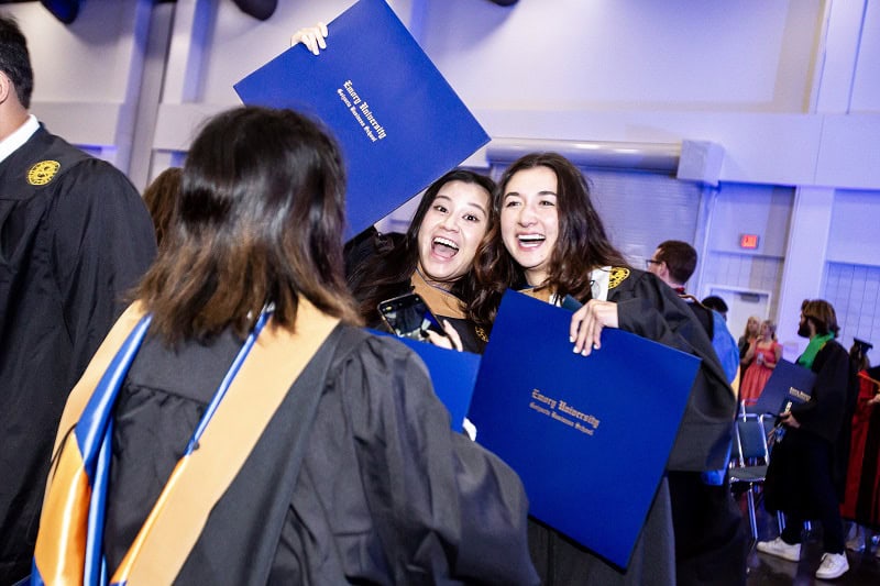Students celebrate with their diplomas during Goizueta Commencement 2024