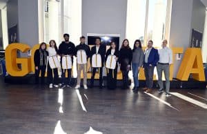 Team Charlie standing in front of Goizueta letters with Goizueta Faculty and UPS Judges